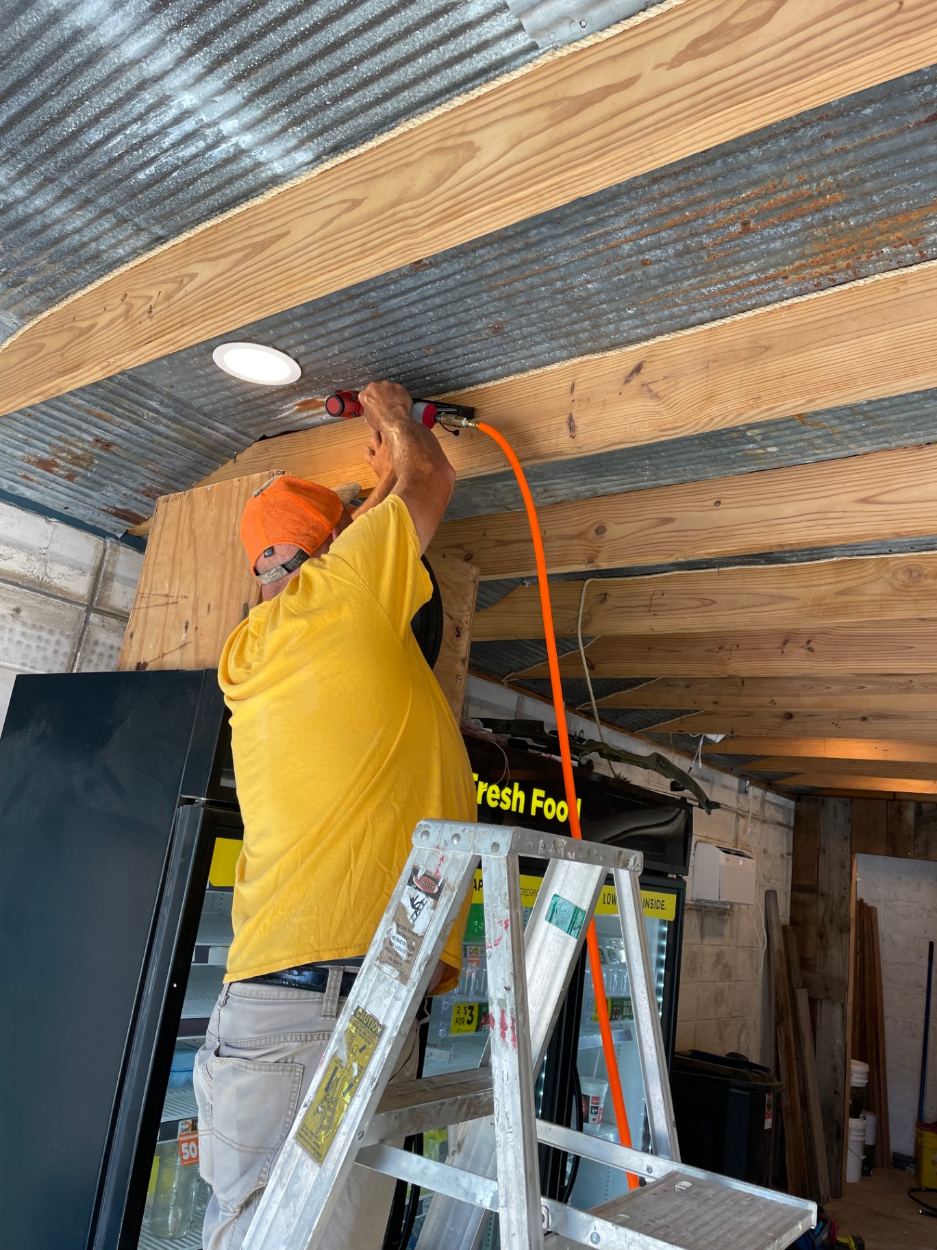 Installing wood and corrugated metal ceiling with recessed lighting