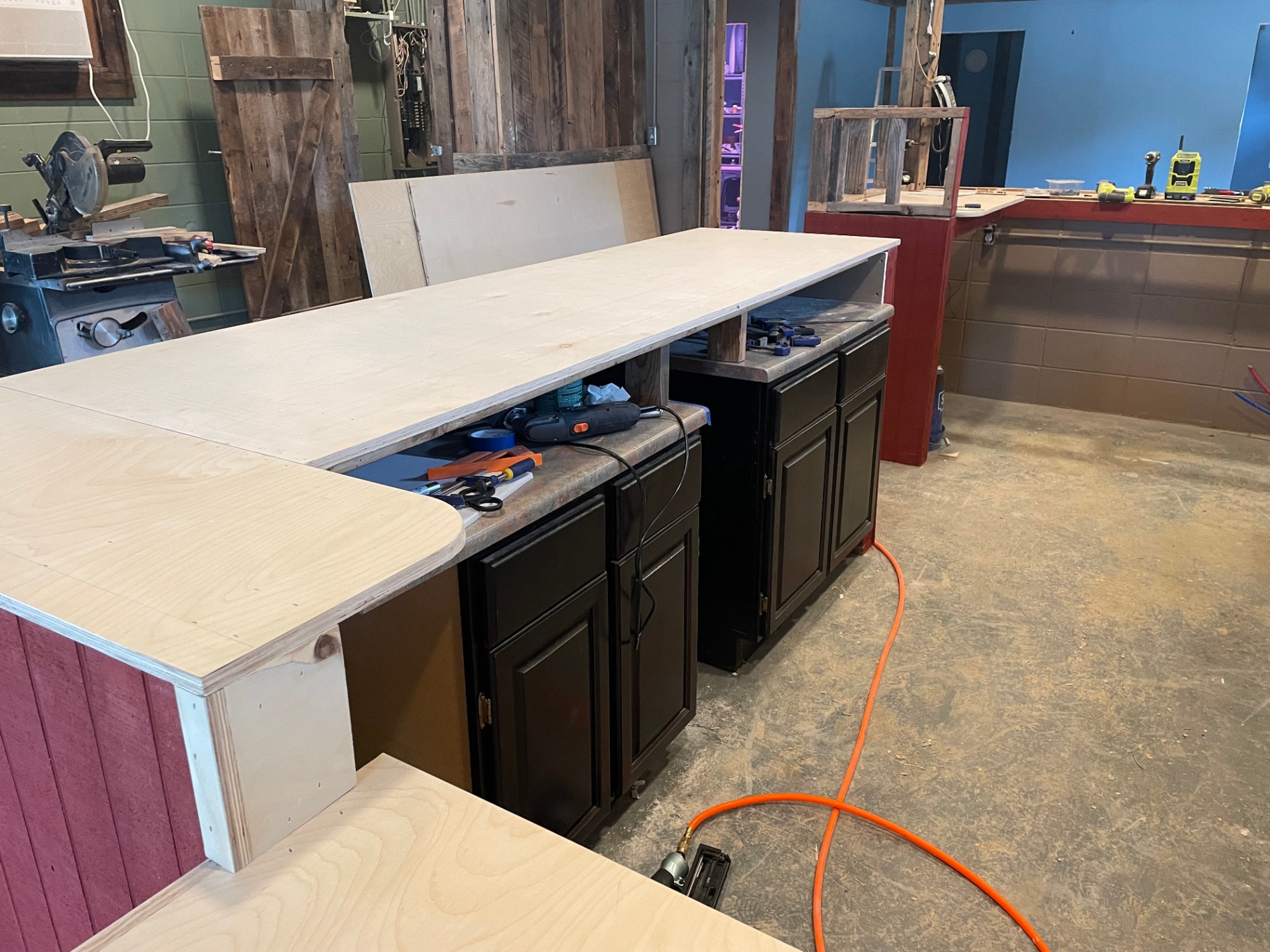 Bar build with countertop laid over black cabinet bases