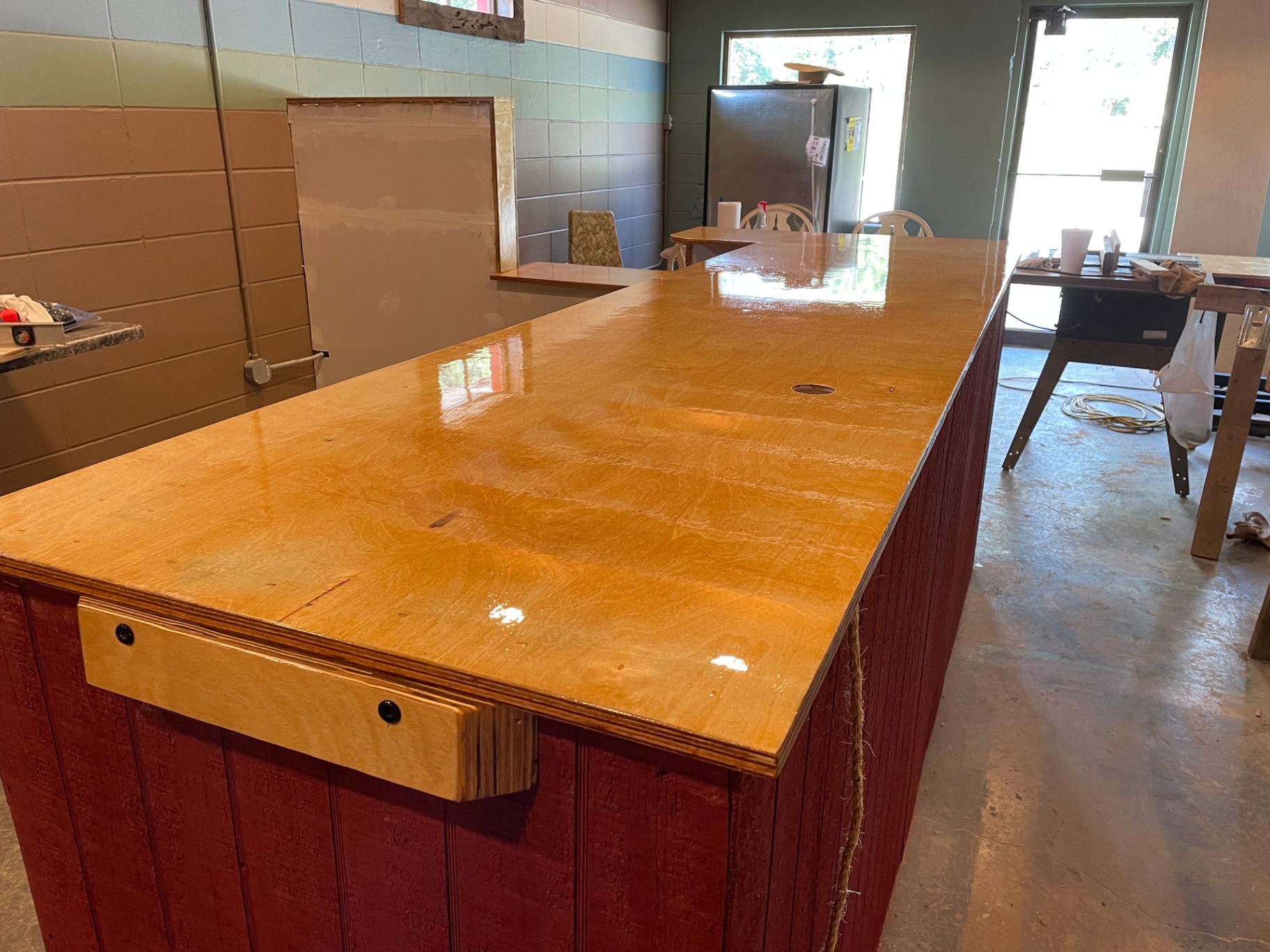 Long L-shaped finished bar top with red base, second angle