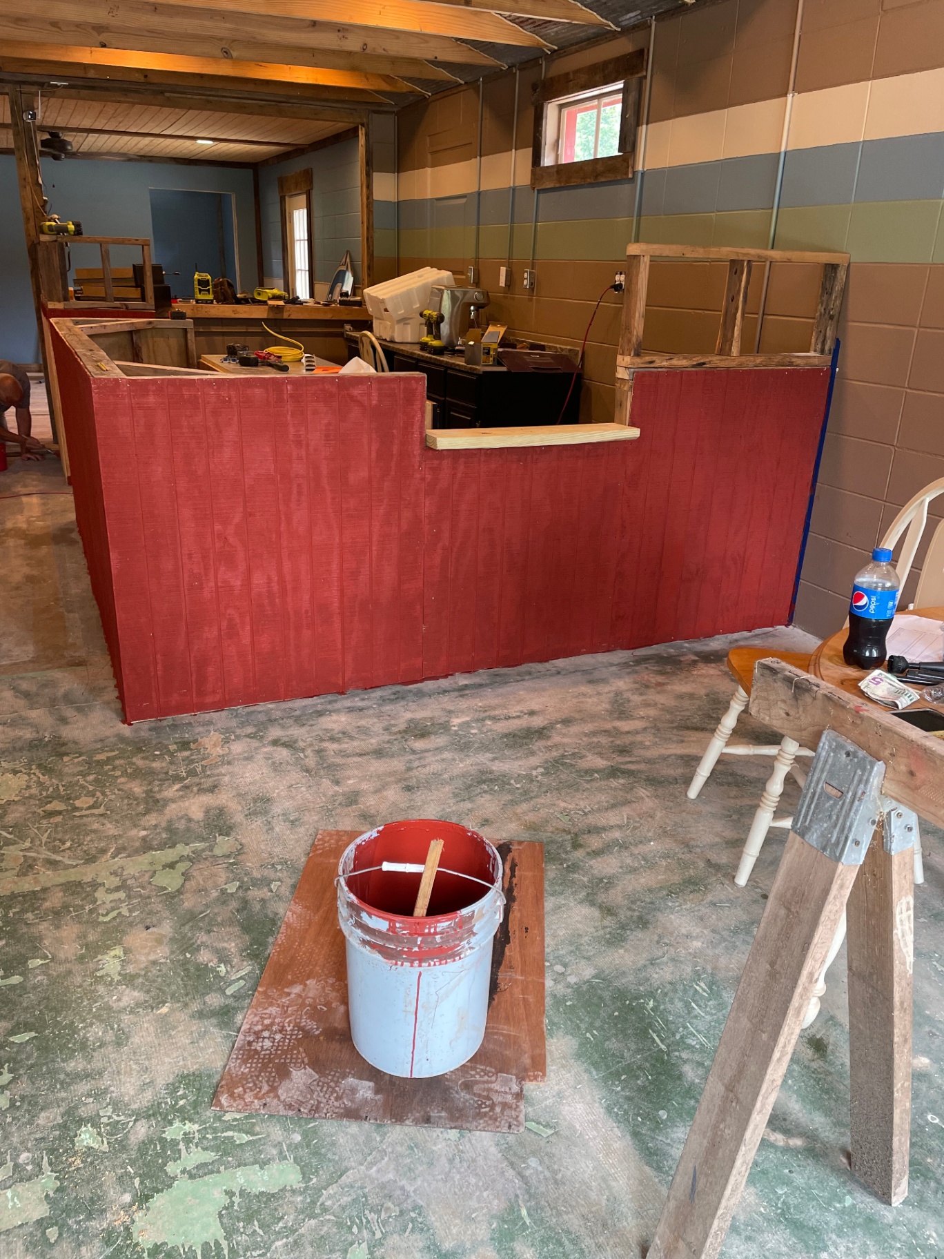 Bar painted red with rustic wood trim taking shape